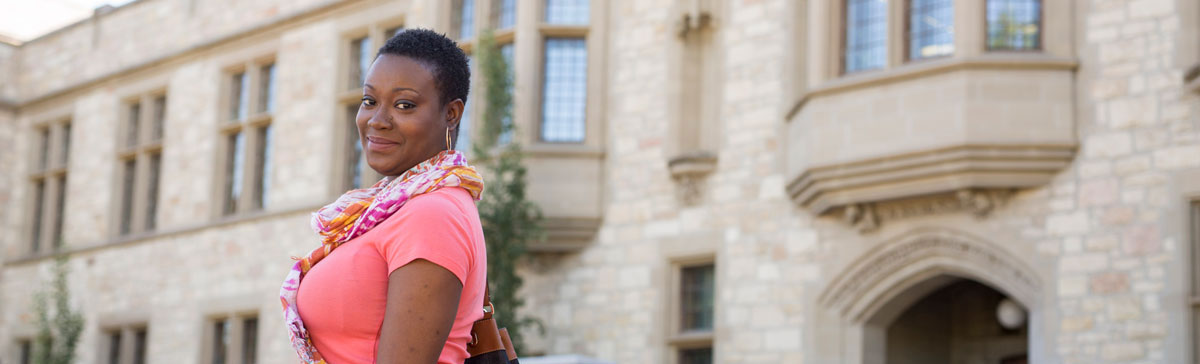 a woman standing with side profile in front of the administration building at the university of Saskatchewan